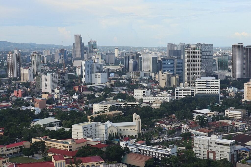 Panoramic view of Cebu City showing modern high-rise buildings, residential neighbourhoods and the city skyline.