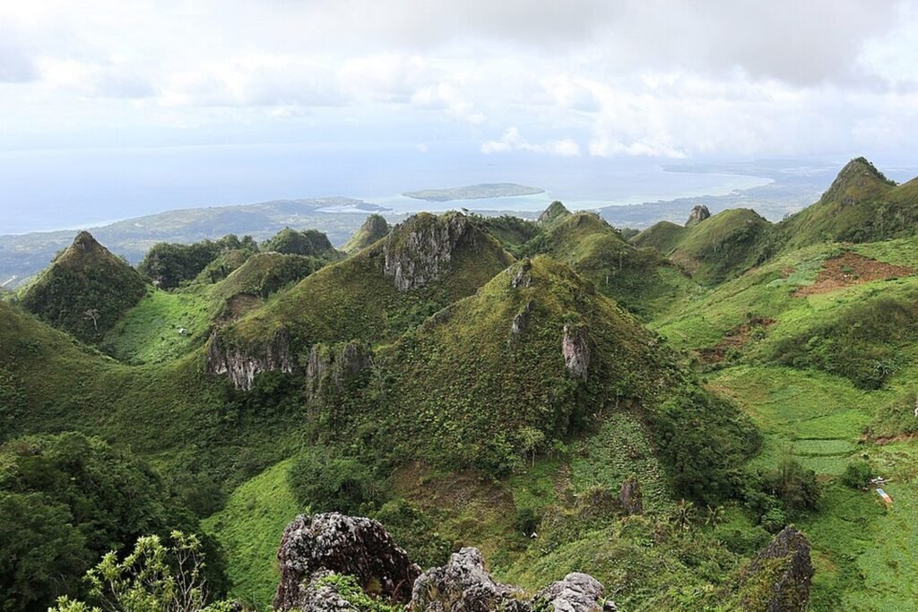 Green mountain peaks and coastal views from Osmeña Peak in Dalaguete, Cebu.